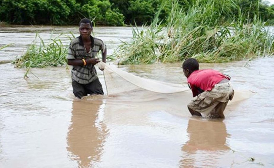 Children work to salvage goods washed away by flood waters in the southern district of Chikwawa in Malawi.