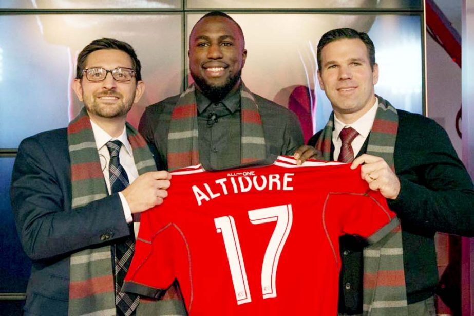 Jozy Altidore (center) poses for a photo with Major League Soccer team Toronto FC's general manager Tim Bezbatchenko (left) and head coach Greg Vanney following a news conference where he was introduced as the teams latest signing in Toronto on Friday.