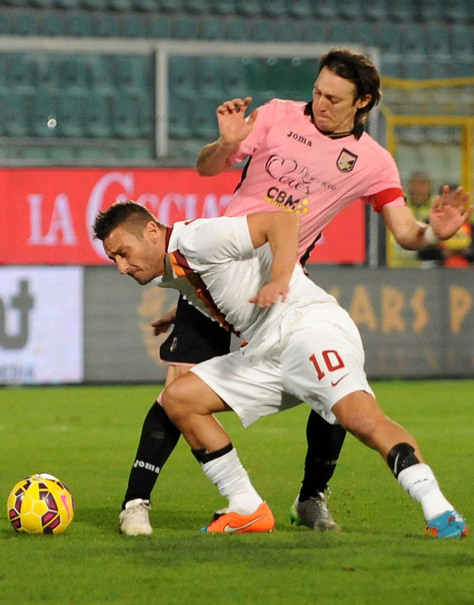 Roma's Francesco Totti (bottom) fights for the ball with Palermo's Edgar Barreto during the Serie A soccer match between Palermo and Roma in Palermo, Italy on Saturday.