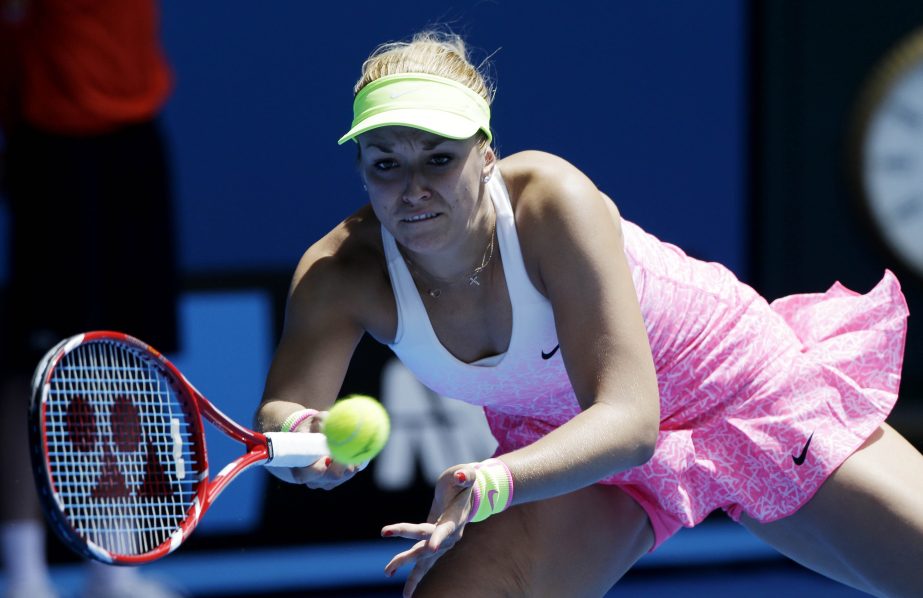 Sabine Lisicki of Germany makes a backhand return during her first round match against Kristina Mladenovic of France at the Australian Open tennis championship in Melbourne, Australia on Monday.