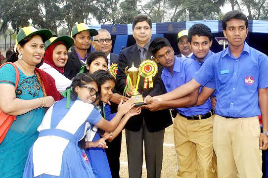 Air Officer Commanding of BAF Base Bangabandhu, Air Vice Marshal M Naim Hassan giving away Champion Trophy to Nabab Siraj-Ud-Doulla house of BAF Shaheen College, Kurmitola for Inter-House Annual Sports Competition-2015 at Dhaka Cantonment on Monday. ISPR