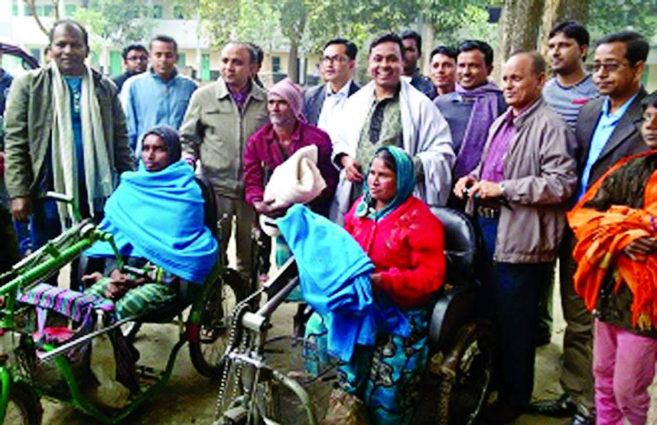 Barrister Jakir Ahmed, Director of Rupali Bank Limited, distributing blankets among the cold affected poor at Nabinagar in Brahmanbaria recently. Abu Shahed Chawdhury UNO of Nabinagar was present.