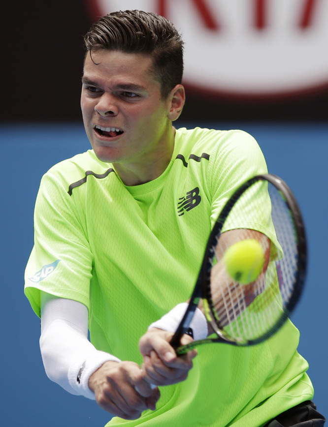 Milos Raonic of Canada makes a backhand return to Illya Marchenko of Ukraine during their first round match at the Australian Open tennis championship in Melbourne, Australia on Tuesday.