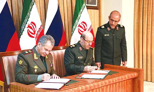 Iran's Defence Minister Hossein Dehqan (centre) and his Russian counterpart Sergei Shoigu signing a military cooperation deal in Tehran on Tuesday.