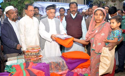 CCC Mayor M Monzoor Alam distributing blankets among the fire victims at Ward No. 38 in the city yesterday.