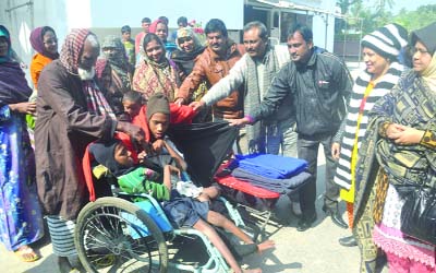 RAJSHAHI: Rajshahi City Corporation Mayor Mosadek Hossain Bulbul distributing blankets among the physically challenged poor people organised by Disabled Welfare and Development Committee and Councilors recently.