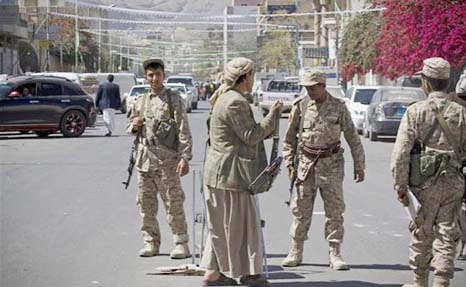 Houthi Shiite Yemeni wearing army uniforms stand guard on a street leading to the presidential palace in Sanaa.