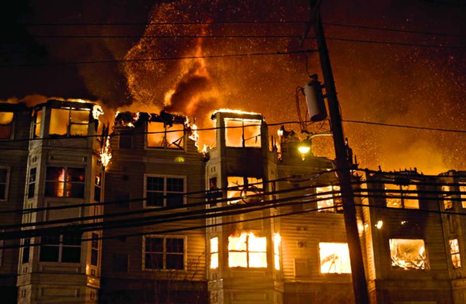 An apartment complex is engulfed by flames, Jan. 21, 2015, in Edgewater, New Jersey