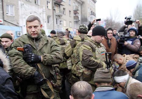 Leader of the self-declared Donetsk People's Republic, Alexander Zakharchenko (L), stands next to kneeling captive Ukrainian soldiers at a bus stop in Donetsk on Thursday.