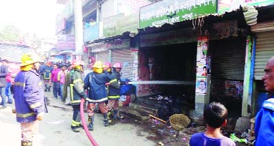 JAMALPUR: Fire service personel trying to bring fire of BNP office under control at Jamalpur on Saturday.