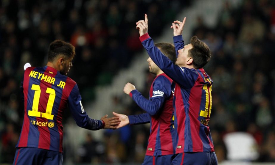 Barcelona's Lionel Messi (right) celebrates after scoring from the penalty spot during a Spanish La Liga soccer match between Elche and Barcelona at the Martinez Valero stadium in Elche, Spain on Saturday.