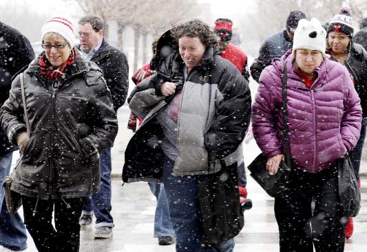 People walk through the snow on Sunday in Chicago.