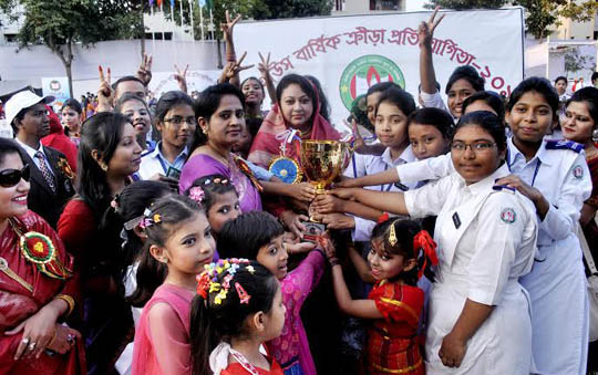 Students of Zahanara Imam House receiving Championship trophy of Inter-House annual sports competition-2015 of Dhaka Cantonment Girls' Public School & College on Monday.