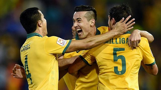 Australia's Jason Davidson celebrates his goal with Mark Milligan and Tim Cahill during the semi final Asian Cup match between Australia and the United Arab Emirates at Hunter Stadium in Newcastle, Australia on Tuesday .