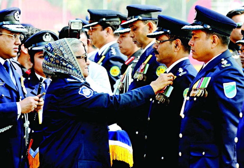 Prime Minister Sheikh Hasina awarding medals to the officers for their outstanding contribution to respective fields on the occasion of Dhaka Metropolitan Police Week at the Rajarbagh Police Line on Tuesday.