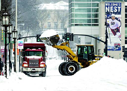 Heavy lifting: Crews clean up the snow in front of City Hall at Court Street in Massachusetts as Juno makes its presence felt. Photo: Internet