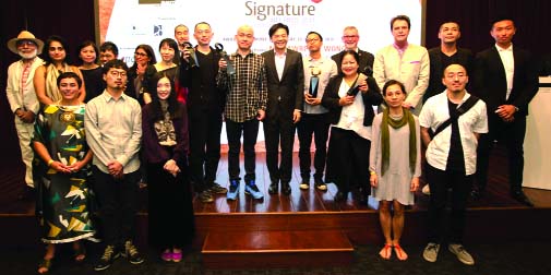 Lawrence Wong, Minister of Culture, Community and Youth of Singapore, poses with the participants of Asia Pacific Breweries (APB) signature Art Prize- 2014 at Singapore art museum on Tuesday.