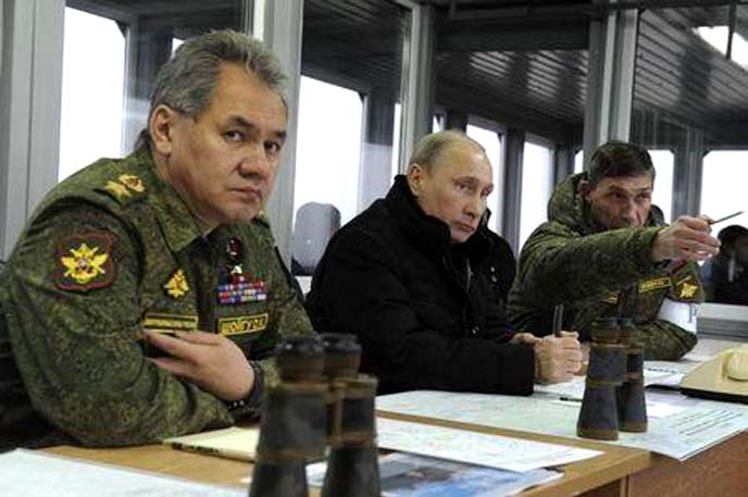 Russia's President Vladimir Putin (centre), Defence Minister Sergei Shoigu (left) and head of the Russian army's main department of combat preparation Ivan Buvaltsev watch military exercises at the Kirillovsky firing ground in the Leningrad region.