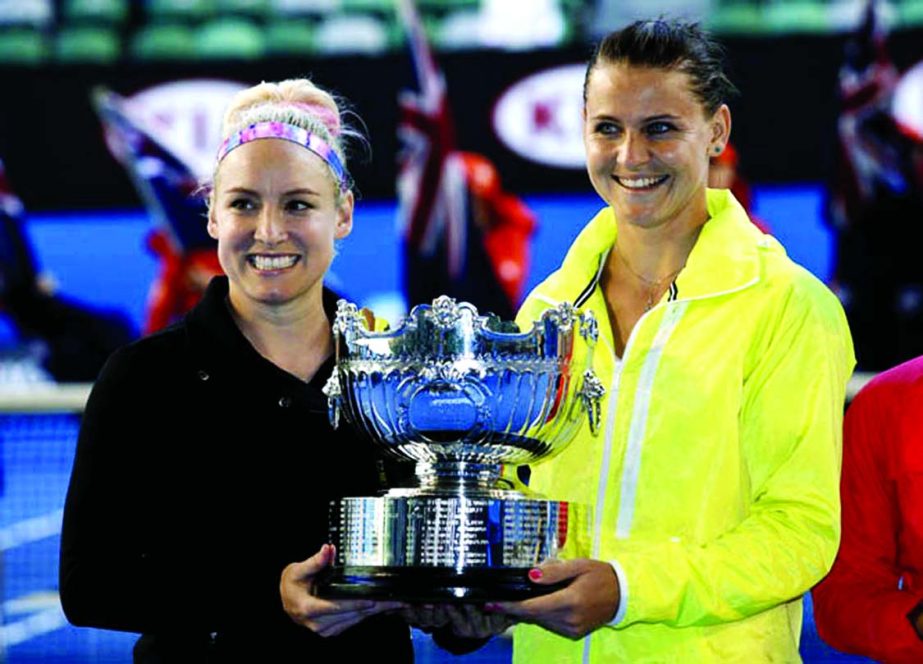 Bethanie Mattek-Sands of the US (left) and Lucie Safarova of the Czech Republic hold the trophy during the awarding ceremony, after defeating Taiwanâ€™s Chan Yung-jan and Chinaâ€™s Zheng Jie in their women's doubles final at the Australian Open