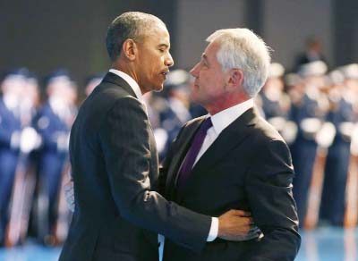 US President Barack Obama (L) hugs outgoing Defence Secretary Chuck Hagel during a farewell ceremony at Joint Base Myer-Henderson Hall in Virginia.