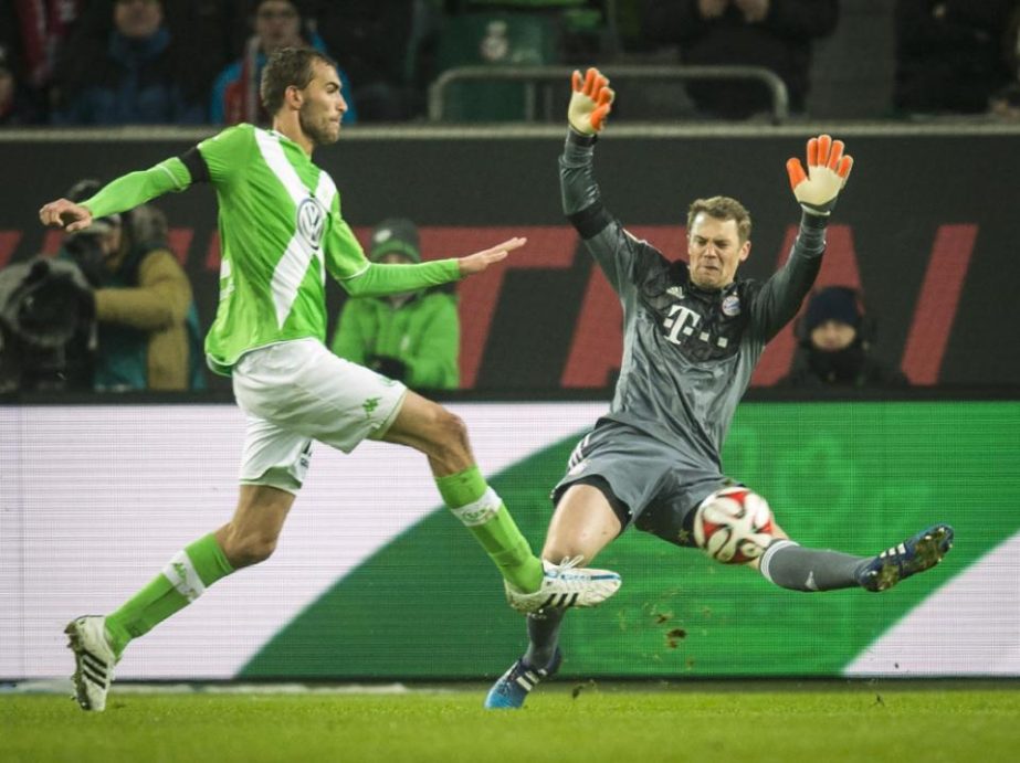 Wolfsburg's Dutch striker Bas Dost (L) shoots the ball during the German first division Bundesliga football match between Wolfsburg and FC Bayern Muenchen in Wolfsburg, Germany on Friday.