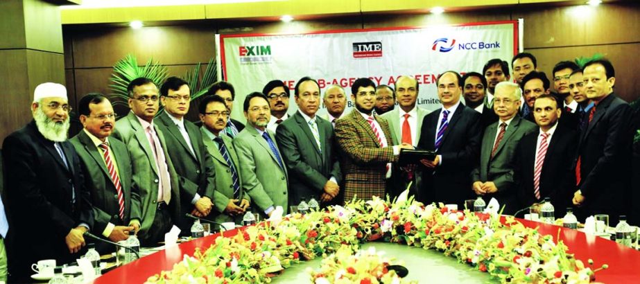 Managing Director of EXIM Bank Dr Mohammed Haider Ali Miah and Managing Director of NCC Bank Golam Hafiz Ahmed, exchanging documents after signing IME sub-agreement for collecting remittance. DMDs of EXIM Bank and NCC Bank, Country Manger of IME and top e