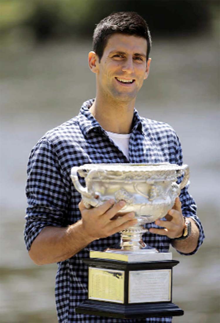 Novak Djokovic of Serbia poses with his Australian Open trophy, the day after defeating Andy Murray of Britain in the men's singles final at the Australian Open tennis championship in Melbourne, Australia, on Monday.