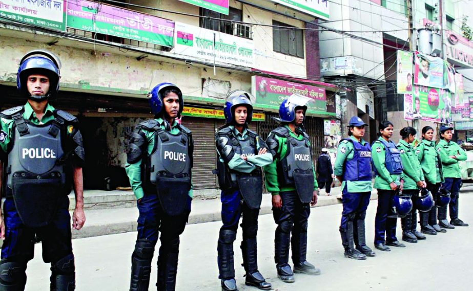 Law-enforcers stand guard in front of the BNP central office in the city's Nayapalton on Thursday for security reasons.