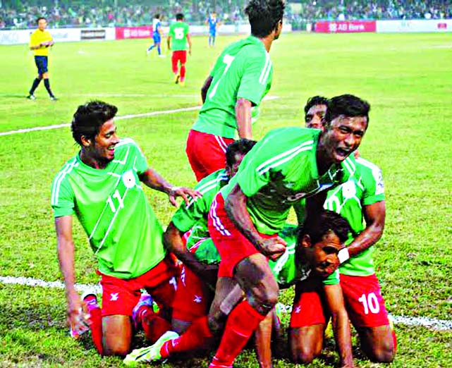 Bangladesh players celebrate after scoring the goal against Thailand in the second semi-final of the Bangabandhu Gold Cup International Football Tournament at the Bangabandhu National Stadium on Friday.