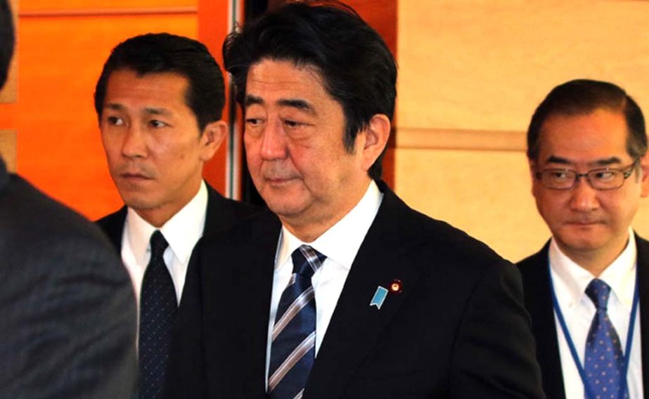 Japanese Prime Minister Shinzo Abe (centre) as he leaves his official residence in Tokyo.