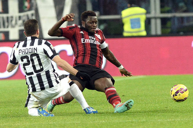 AC Milan' Sulley Muntari (right) is challenged by Juventus' Simone Padoin during a Serie A soccer match at the Juventus stadium, in Turin, Italy on Sunday.