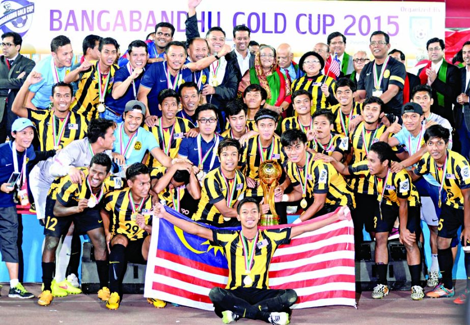 Members of Malaysia Football team, the champions of the Bangabandhu Gold Cup International Football Tournament with Prime Minister Sheikh Hasina pose with the championship trophy at the Bangabandhu National Stadium on Sunday. Photo: Moin Ahamed