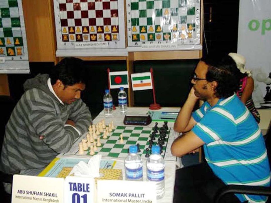 IM Abu Sufian Shakil (left) of Bangladesh and IM Palit Somak (right) of India in action during their match of the CJKS-Prime Distributions Group Grand Masters Chess Competition at MA Aziz Stadium in Chittagong on Tuesday.