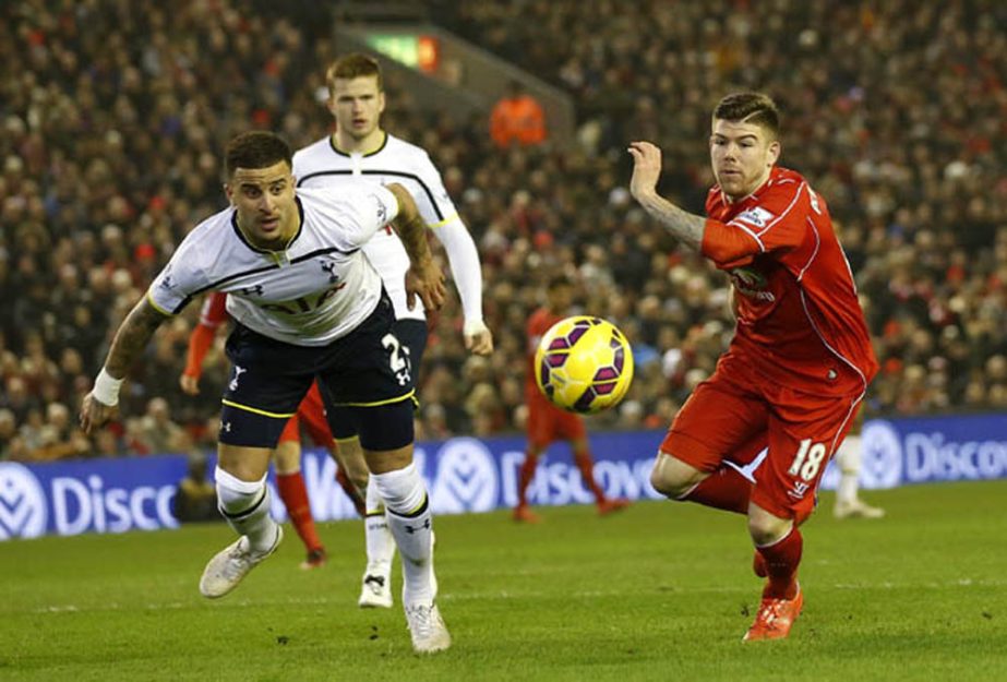 Liverpool's Alberto Moreno (right) and Tottenham's Kyle Walker challenge for the ball during the English Premier League soccer match between Liverpool and Tottenham Hotspur at Anfield Stadium, Liverpool, England on Tuesday .