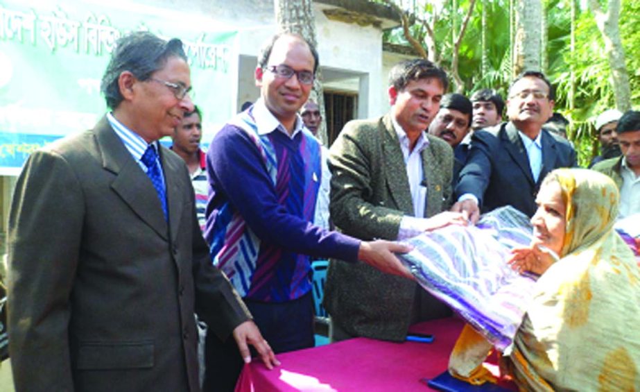 Gosh Sanat Kumar, Upazila Chairman; Md Mahabubur Rahman, UNO and Md Abdul Hamid Khan, Zonal Manager of BHBFC, Khulna distributing blankets among cold-hit poor at Tegharia Primary School of Tala Upazila under Satkhira recently.