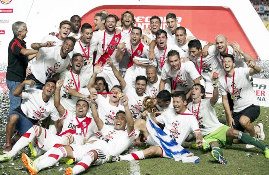 River Plate`s team players celebrate after defeating San Lorenzo at the Recopa Sudamericana final soccer match, in Buenos Aires, Argentina on Wednesday.