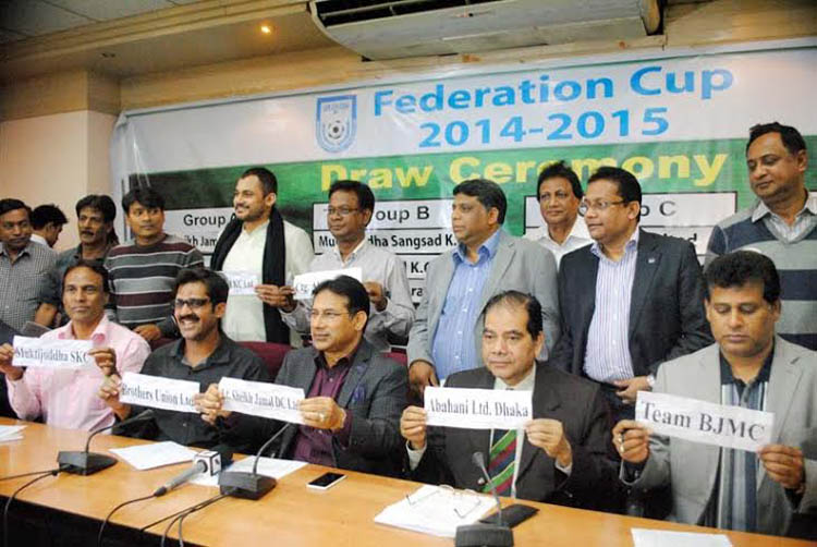 The officials of BFF, former players of Bangladesh National Football team and the representatives of the participating clubs of Federation Cup showing the names of the teams of the Federation Cup during the Draw Ceremony of Federation Cup at the BFF House