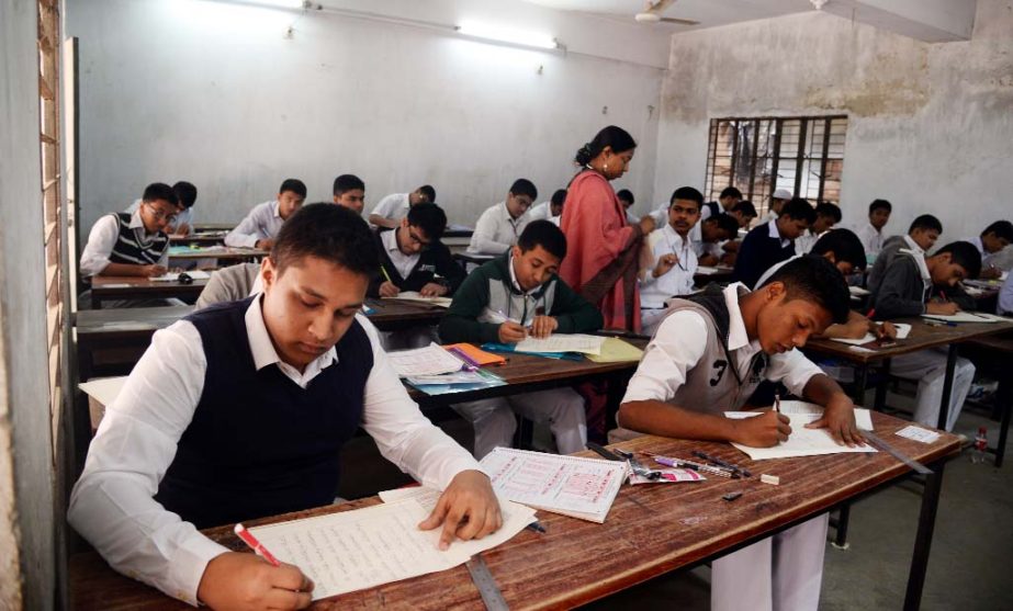 SSC examinees are seen writing their answer scripts at an examination hall in the capital. This photo was taken from Banglabazar Girlâ€™s High School Centre on Friday.