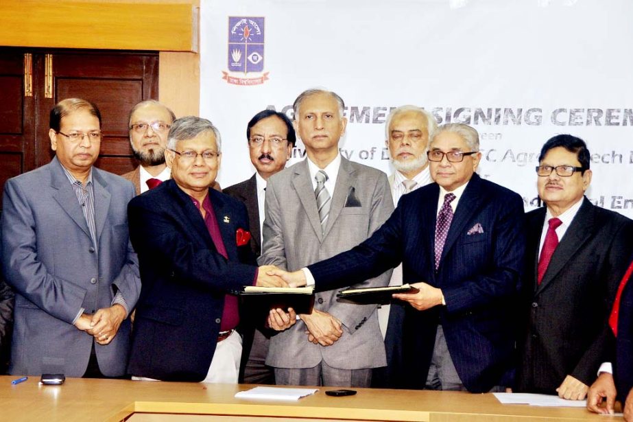 Dhaka University Pro-Vice Chancellor (Administration) Prof Dr Shahid Akhtar Hossain and Chairman of AFC Agro Biotech Ltd are seen exchanging the MoU papers on behalf of their representative at the latter's office on Thursday. DU Vice-chancellor AAMS Aref