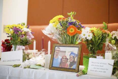 A makeshift memorial for Deah Shaddy Barakat, his wife Yusor Mohammad and Yusor's sister Razan Mohammad Abu-Salha, who were killed by a gunman, is pictured inside of the University of North Carolina School of Dentistry, in Chapel Hill, North Carolina