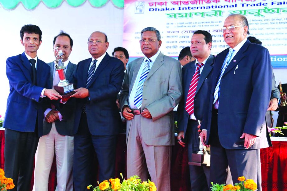 Commerce Minister Tofail Ahmed, handing over second prize under premium pavilion category to Md Raihan, first senior additional director (marketing) of Walton at the 20th Dhaka International Trade Fair-2015 recently. Chairman of the Parliamentary Standing