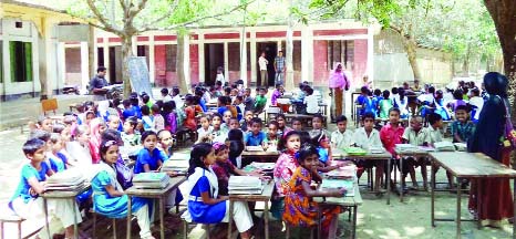 JAMALPUR: Students of Duttarchar Primary School attending their classes under the open sky. This picture was taken on Friday.