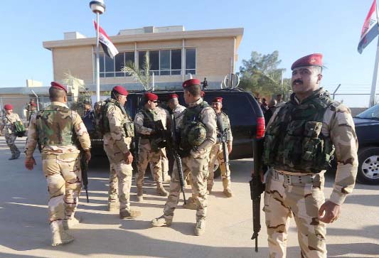 Iraqi soldiers stand at the Al-Asad air base, in Iraq's mainly Sunni Anbar province.