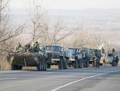 Members of the Ukrainian armed forces ride on military vehicles near Artemivsk, eastern Ukraine, on Friday.