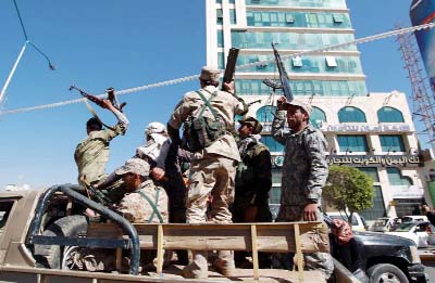 Shiite Huthi fighters drive through the Yemeni capital Sanaa on Wednesday.