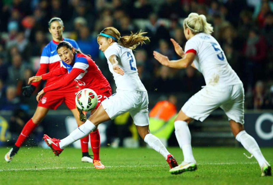 Christen Press of the United States shoots past Alex Scott (2) and Steph Houghton of England (5) during the Women's Friendly International match between England and USA on Friday in Milton Keynes, England.