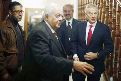 Quartet Representative to the Middle East and former British prime minister Tony Blair Â® stands next to Palestinian Minister of Work Mamoun Abu Shahla during Blair's visit to Gaza City.