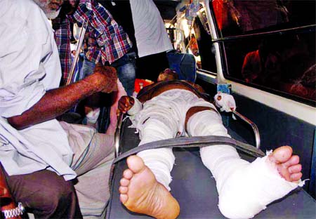 One of the seven injured, who received severe injuries in bomb blasts during procession at Gulshan on Monday, being taken to hospital.