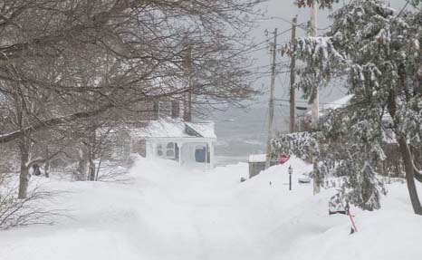 Snow covers 1st Ave during winter storm Neptune which dropped over a foot of snow on Monday in Scituate, Massachusetts.