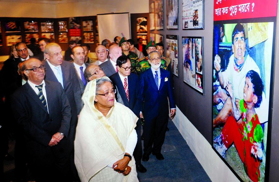 Prime Minister Sheikh Hasina witnessing the photo exhibition of BNP-Jamaat's violence at the National Museum Gallery in the city on Tuesday. Foreign diplomats were also present on the occasion.BSS photo